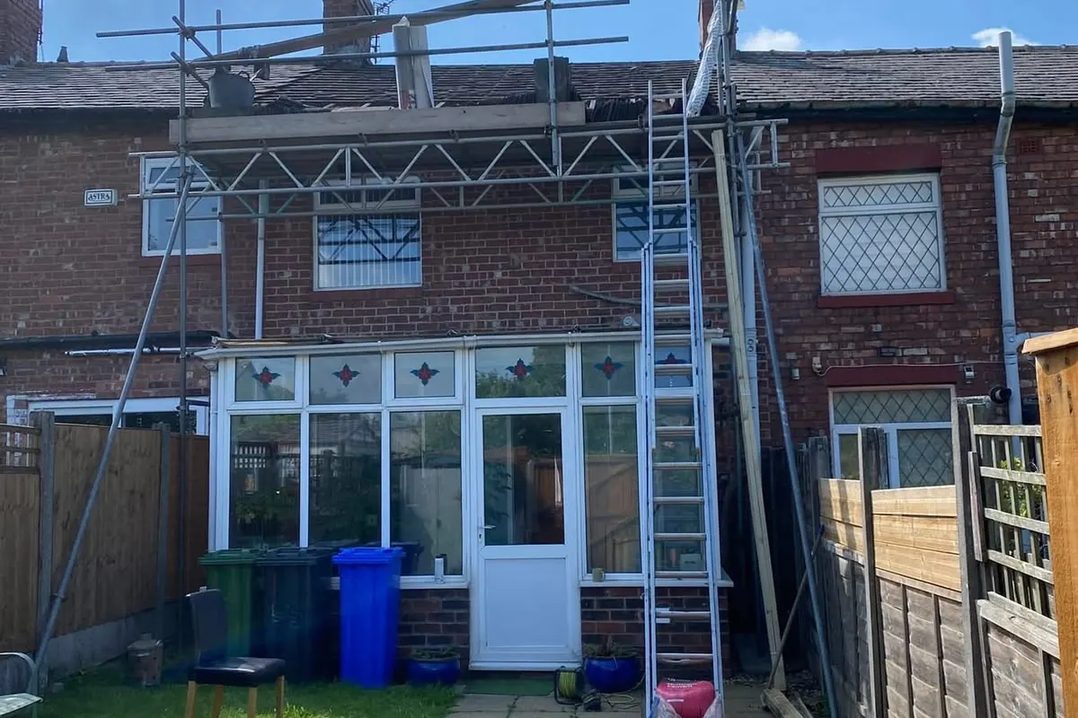 Scaffold up at the back of a terraced house for roof work by All Fix Roofing